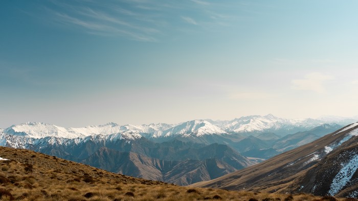 4K snow-capped mountains with dry grass foreground