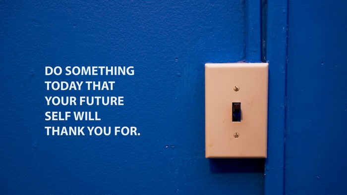 Motivational quote on blue wall with light switch