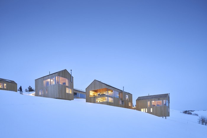 Modern wooden cabins on a snowy hillside