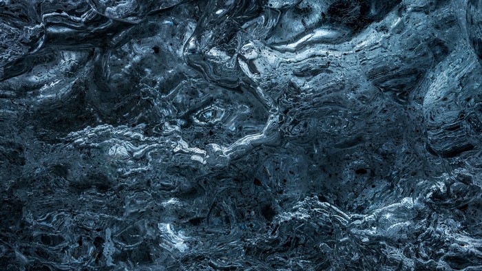 Close-up of blue ice texture with swirling patterns