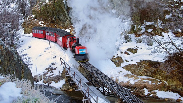 Steam train with Argentine flag in snowy Patagonia