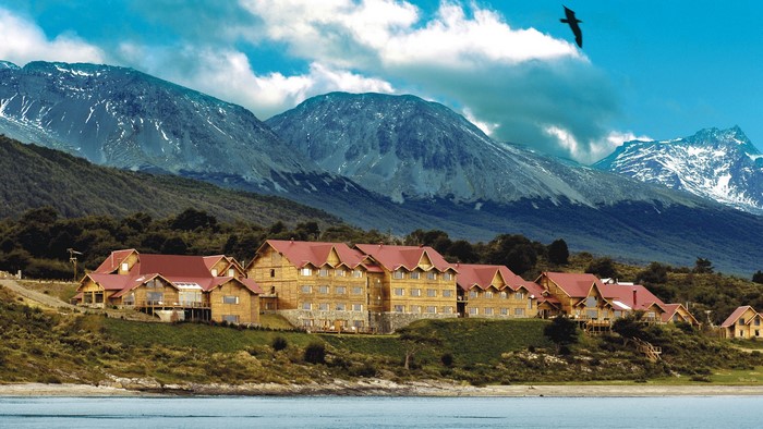 Wooden lodge buildings on a hill with mountains