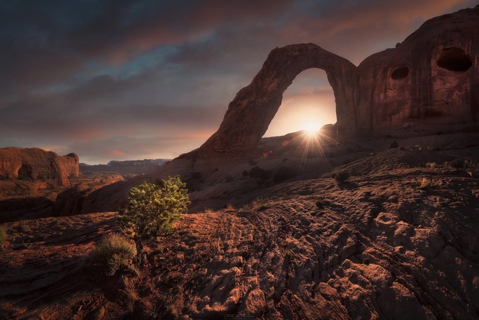 Sunrise through Corona Arch in Utah desert