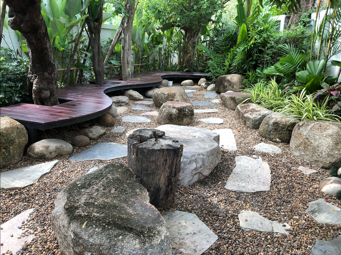 Japanese garden with wooden walkway and rocks