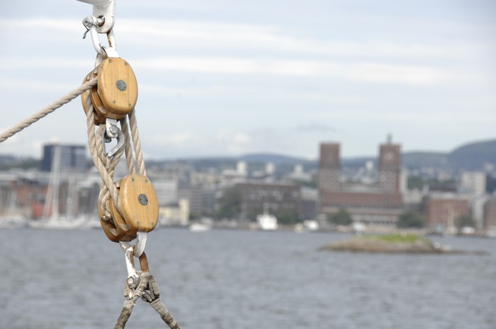 Ropes and blocks on a boat with Oslo in the background
