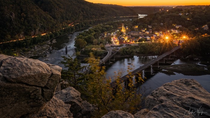 Harpers Ferry town and river at sunset with bridges