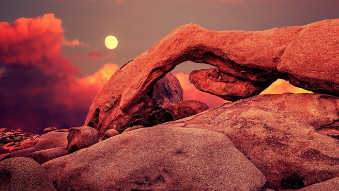 Arch rock formation in Joshua Tree National Park at sunset