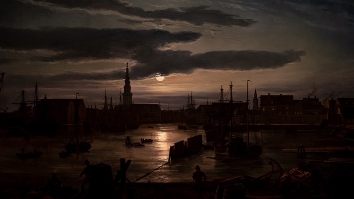 Moonlit harbor with ships and buildings