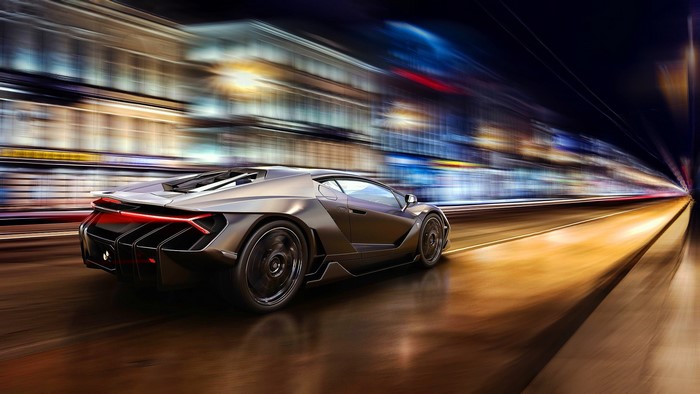 Lamborghini Centenario driving through a city at night