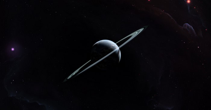Planet with rings in deep space with nebulae