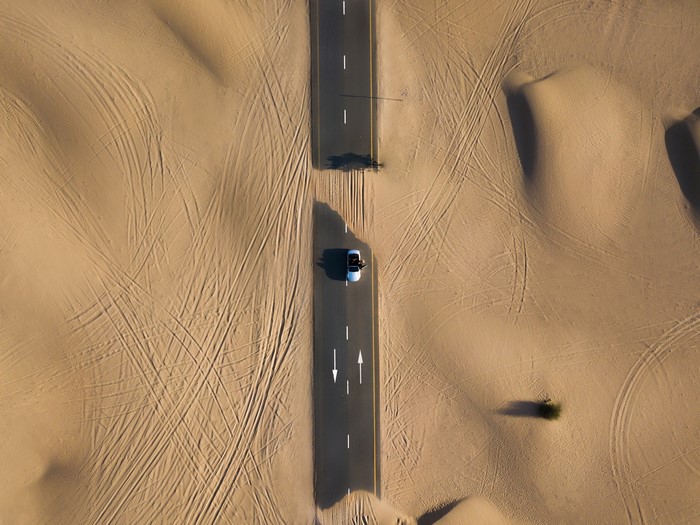 Aerial View of Road Through Desert Sand