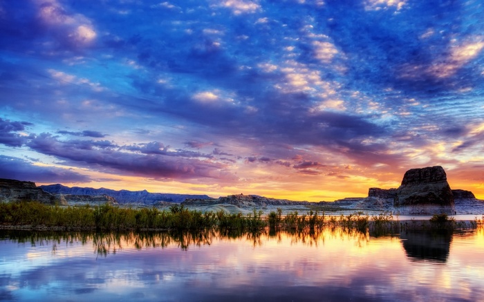 Sunset over a calm lake with rock formations