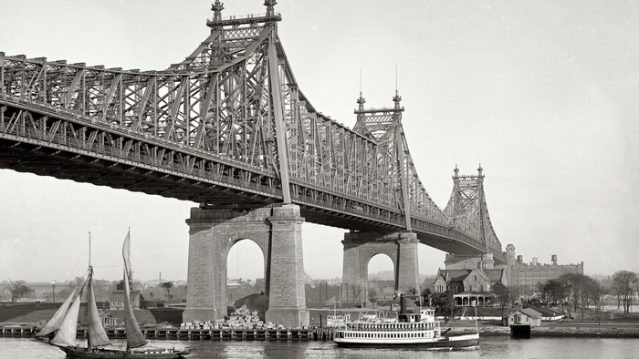Queensboro Bridge and boats on water, New York City