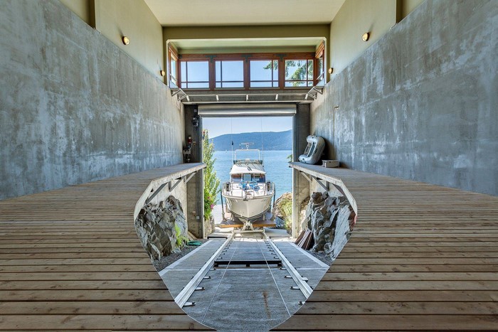 Boat in a boathouse with a view of a lake