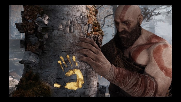 Kratos from God of War places hand on tree with handprint