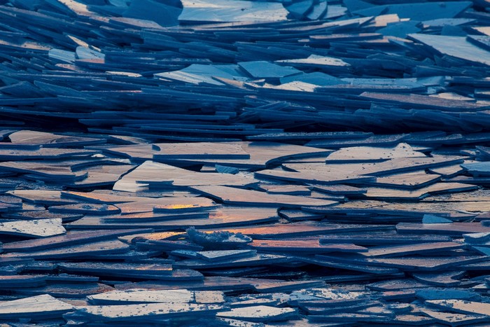 Ice floes on a frozen lake at sunset