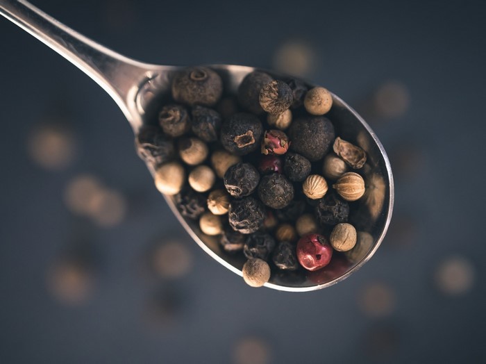 Spoonful of mixed peppercorns and spices