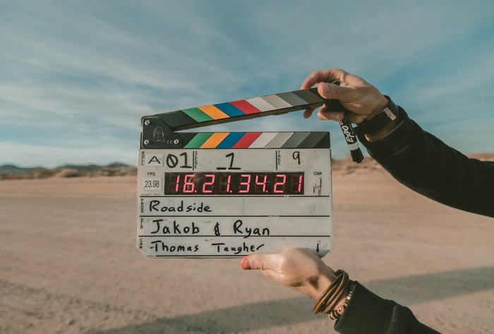 Movie clapperboard with desert background