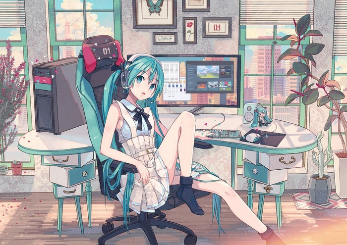 Hatsune Miku sitting at a computer desk