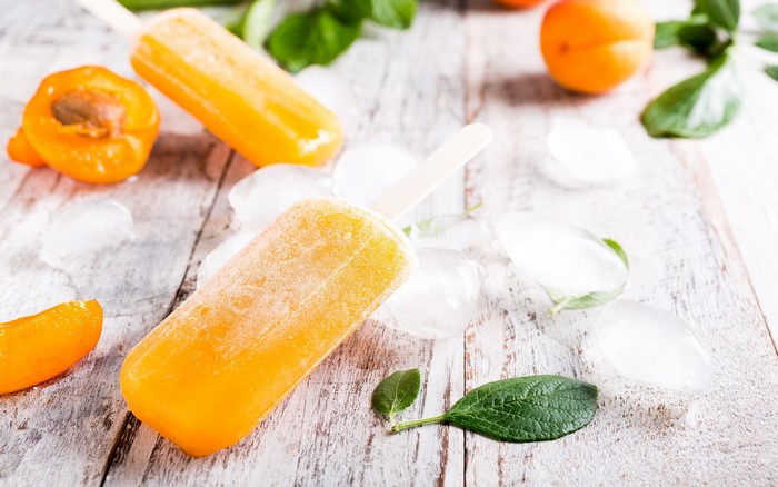Orange popsicles with apricots and ice
