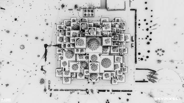Aerial view of a modern building complex covered in snow