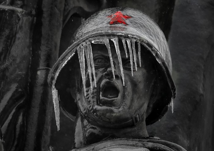 Statue of Soviet soldier in winter with icicles