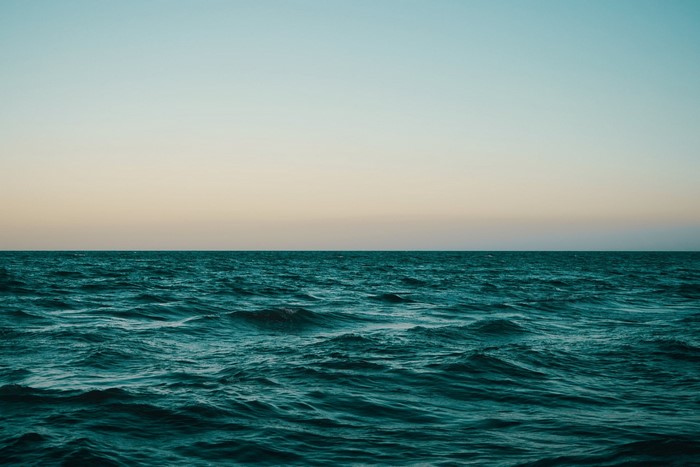 Ocean horizon at dusk with gentle waves