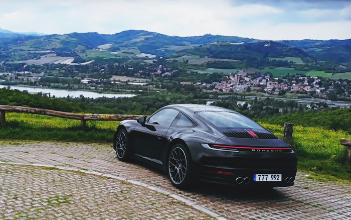 Black Porsche 911 992 with scenic landscape