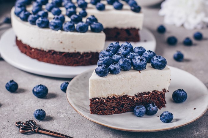 Chocolate cake with white frosting and blueberries