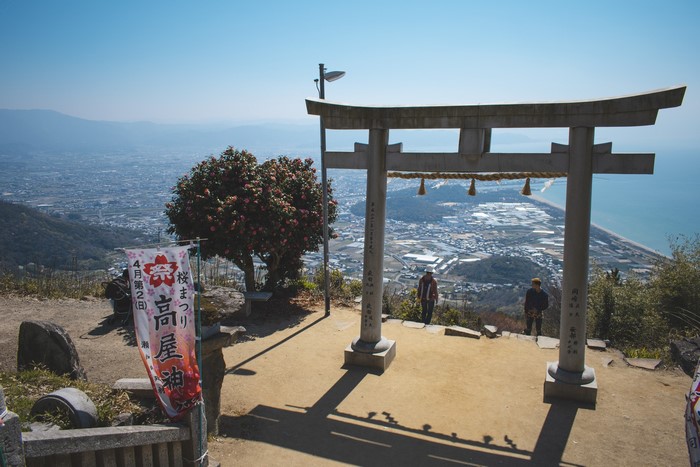 Shrine Torii Gate Overlooking Coastal City in Japan