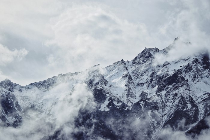 Snowy mountain peaks shrouded in clouds
