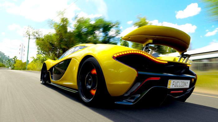 Yellow McLaren P1 driving on a road in Forza Horizon 3