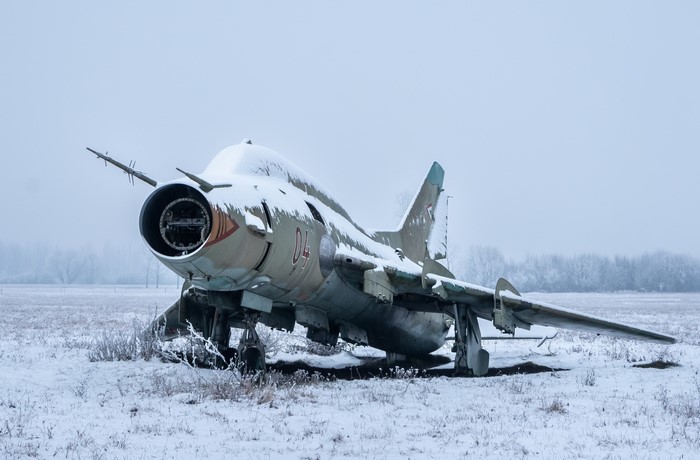 Abandoned military aircraft covered in snow