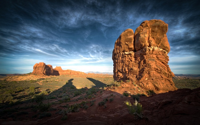 Rock formations in Arches National Park under a cloudy sky