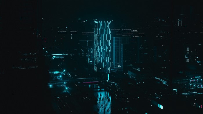 Futuristic cityscape at night with glowing buildings