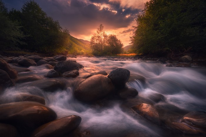 River flowing over stones at sunset
