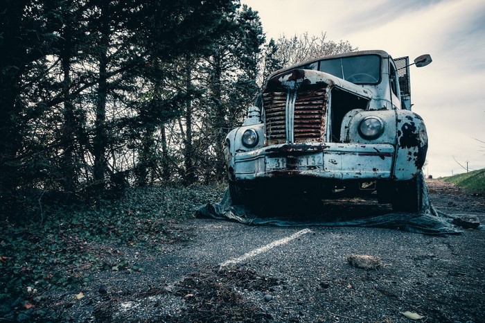 Abandoned rusty truck on a road