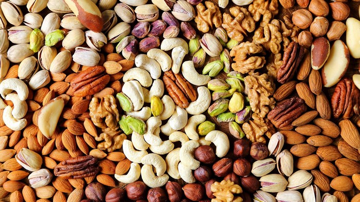 Assortment of nuts including walnuts, pistachios, almonds, and pecans