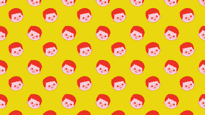 Pattern of cartoon boy faces on yellow background