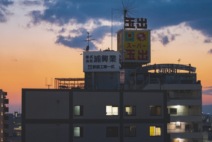 Osaka Japan cityscape at sunset with illuminated buildings