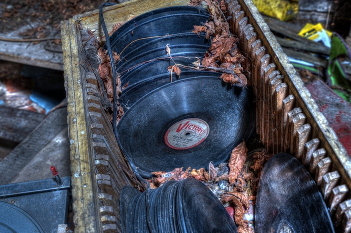Stack of old vinyl records in a wooden crate