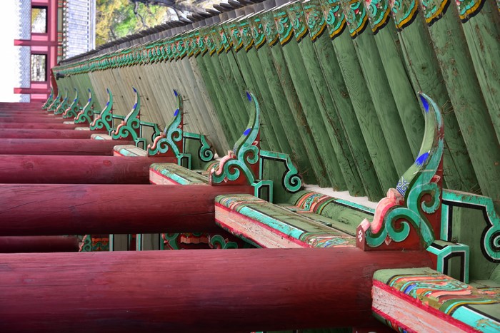 Korean Architecture with Red Wooden Beams and Green Roof