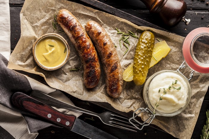 Sausages with mustard, pickles, and mashed potatoes