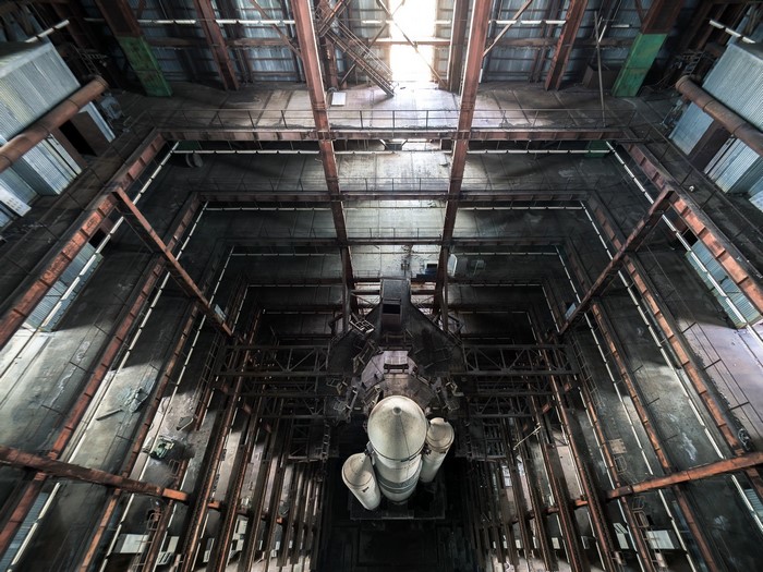 Inside a large industrial building with a rocket