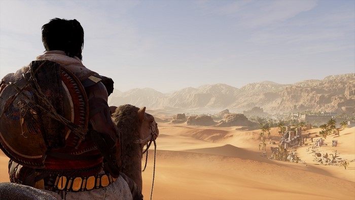 Bayek riding a camel in Assassin's Creed Origins desert landscape