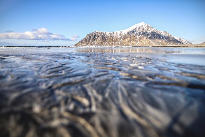 Snow-capped mountain and beach in Lofoten, Norway