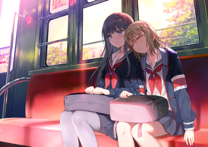 Two schoolgirls on a train, one sleeping