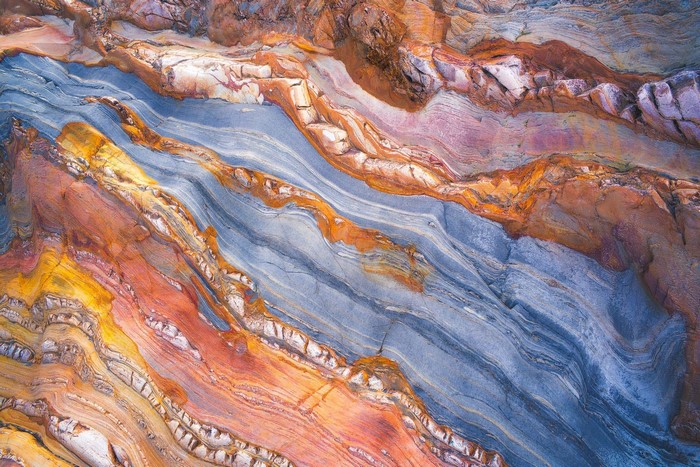 Aerial view of colorful rock strata with abstract patterns