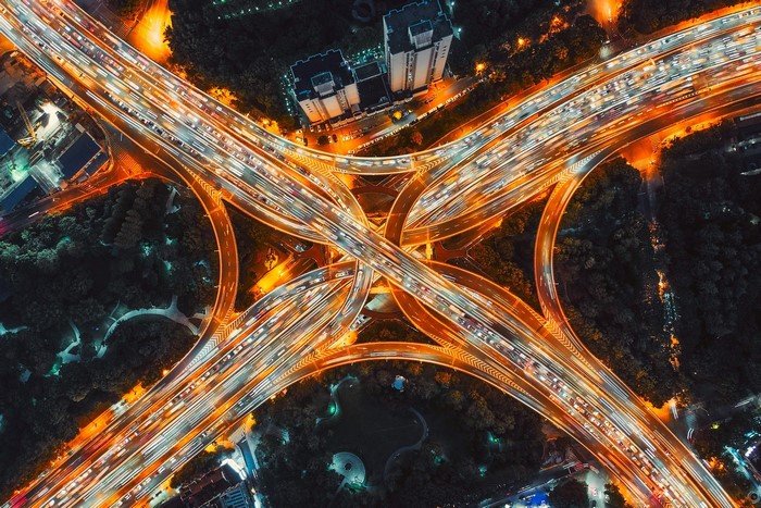 Aerial view of a busy city highway interchange at night