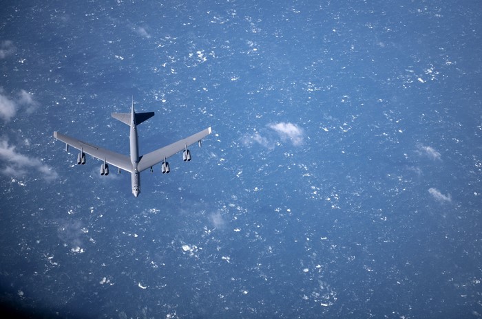 Boeing B-52 Stratofortress bomber flying over the ocean